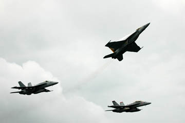 Pacific Ocean (March 3, 2005) - Commanding Officer, Strike Fighter Squadron Two Seven (VFA-27), Cmdr. James Bynum, breaks formation as the departing commanding officer during a change-of-command ceremony over USS Kitty Hawk (CV 63). Cmdr. Kevin Mannix, VFA-27's former executive officer, took command of the squadron during the fly-by. Currently under way in the 7th Fleet area of responsibility (AOR), Kitty Hawk demonstrates power projection and sea control as the U.S. Navy's only permanently forward-deployed aircraft carrier, operating from Yokosuka, Japan. (U.S. Navy photo by Photographer's Mate 3rd Class Bo Flannigan)
